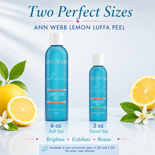 Load image into Gallery viewer, Two bottles of Ann Webb Lemon Luffa Peel shown in full size and travel size, styled with fresh lemons, white flowers, and green leaves on a light blue background with promotional text.