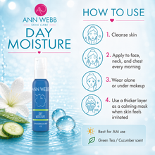 Load image into Gallery viewer, Ann Webb Skin Care Day Moisture bottle shown on a bright blue promotional graphic with usage steps, cucumber slices, water droplets, and a white flower. The bottle is blue with white text and a small green band near the bottom.