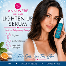 Load image into Gallery viewer, A promotional skincare ad for Ann Webb Skin Care Lighten Up Serum. A woman with long dark hair holds a teal pump bottle of the serum against a light blue water-textured background.