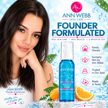 Load image into Gallery viewer, A promotional skincare ad featuring a woman resting her head on her hand beside a bottle of Ann Webb Skin Care Red Less Serum. The ad includes large text, icons, and orange slices on a bright icy blue background.
