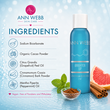 Load image into Gallery viewer, Ann Webb Skin Care Brighten Up Ceremonial Developer 2oz bottle shown next to its ingredients list on a light blue water-textured background with grapefruit, cinnamon, and mint props.