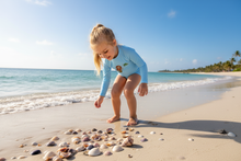 Load image into Gallery viewer, Child collecting seashells wearing rash guard