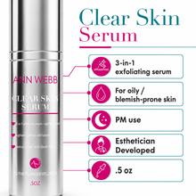 Load image into Gallery viewer, A silver Ann Webb Clear Skin Serum bottle shown next to a feature callout graphic listing benefits such as exfoliating, suitable for oily/blemish-prone skin, PM use, esthetician developed, and .5 oz.
