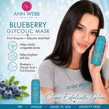 Load image into Gallery viewer, A woman holds a bottle of Ann Webb Skin Care Blueberry Glycolic Mask against a light blue graphic background with product text, ingredient icons, blueberries, and branding.
