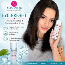 Load image into Gallery viewer, A woman with long dark hair holds a bottle of Ann Webb Eye Bright eye cream next to a product shot of the white and pink bottle. The image features promotional text highlighting the benefits of the eye cream, including reducing dark circles and puffiness, on a light blue background with water droplets.
