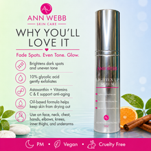 Load image into Gallery viewer, Ann Webb Skin Care LightenUp Serum bottle on a light blue gradient background with product benefits text and decorative leaves, stones, and orange slices. The bottle is silver with pink and white text.
