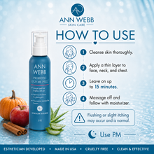 Load image into Gallery viewer, Ann Webb Probiotic Enzyme Peel 2 bottle shown on a light blue water-textured background with usage instructions, icons, and product details. The bottle is blue with white text and a white pump, with small decorative fruit and aloe props near the base.
