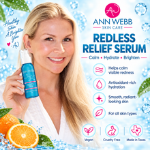 Load image into Gallery viewer, A promotional skincare graphic for Ann Webb Skin Care Redless Relief Serum. A smiling blonde woman in a white robe holds a blue serum bottle on the left, while the right side features product benefits, icons, and branding over a light blue water-themed background with citrus slices.
