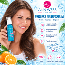 Load image into Gallery viewer, A promotional graphic for Ann Webb Skin Care Redless Relief Serum, featuring a smiling woman holding a blue bottle against a bright icy blue background with water splashes, oranges, and product benefits text.
