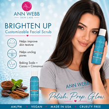 Load image into Gallery viewer, A promotional graphic for Ann Webb Skin Care Brighten Up Customizable Facial Scrub. A woman with long dark hair holds a blue bottle of the facial scrub, with a second bottle shown beside it.
