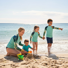 Load image into Gallery viewer, Kids BLue Green Abstract Print Rash Guards Whimsy FIt Mix and Match “Sink or Swim” Matching Mom Mom with Three Kids on Beach
