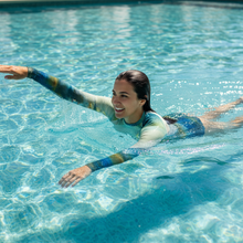 Load image into Gallery viewer, Women's Rash Guard Texas Tea Whimsy Fit UPF 50+ Long Sleeve Swim Shirt Swimming action shot
