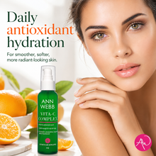 Load image into Gallery viewer, Ann Webb Vita-C Complex facial toner bottle shown next to a close-up of a woman with smooth, radiant skin, with oranges and green leaves in the background and promotional text reading 'Daily antioxidant hydration'.
