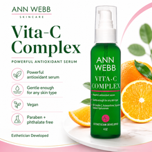Load image into Gallery viewer, Ann Webb Skincare Vita-C Complex serum bottle in green with a white pump, shown on a white background with orange slices, leaves, and marketing text.
