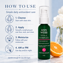 Load image into Gallery viewer, Ann Webb Vita-C Complex skincare serum bottle shown on a light blue background with a 'How to Use' guide on the left and an orange slice on the right.
