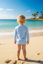 Load image into Gallery viewer, Back view of rash guard with text - child at beach
