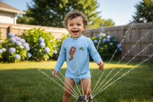 Load image into Gallery viewer, Child playing in sprinkler wearing rash guard
