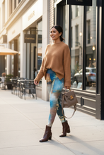 Load image into Gallery viewer, Woman in coffee shop wearing Whimsy Fit  Texas Tea leggings with sweater
